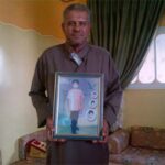 Abu Habel father with pic of his minor son he was denied to visit in prison